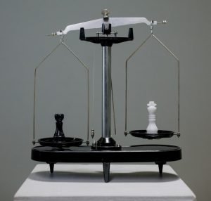 A balancing scale; direct vs. non-direct recognition life insurance